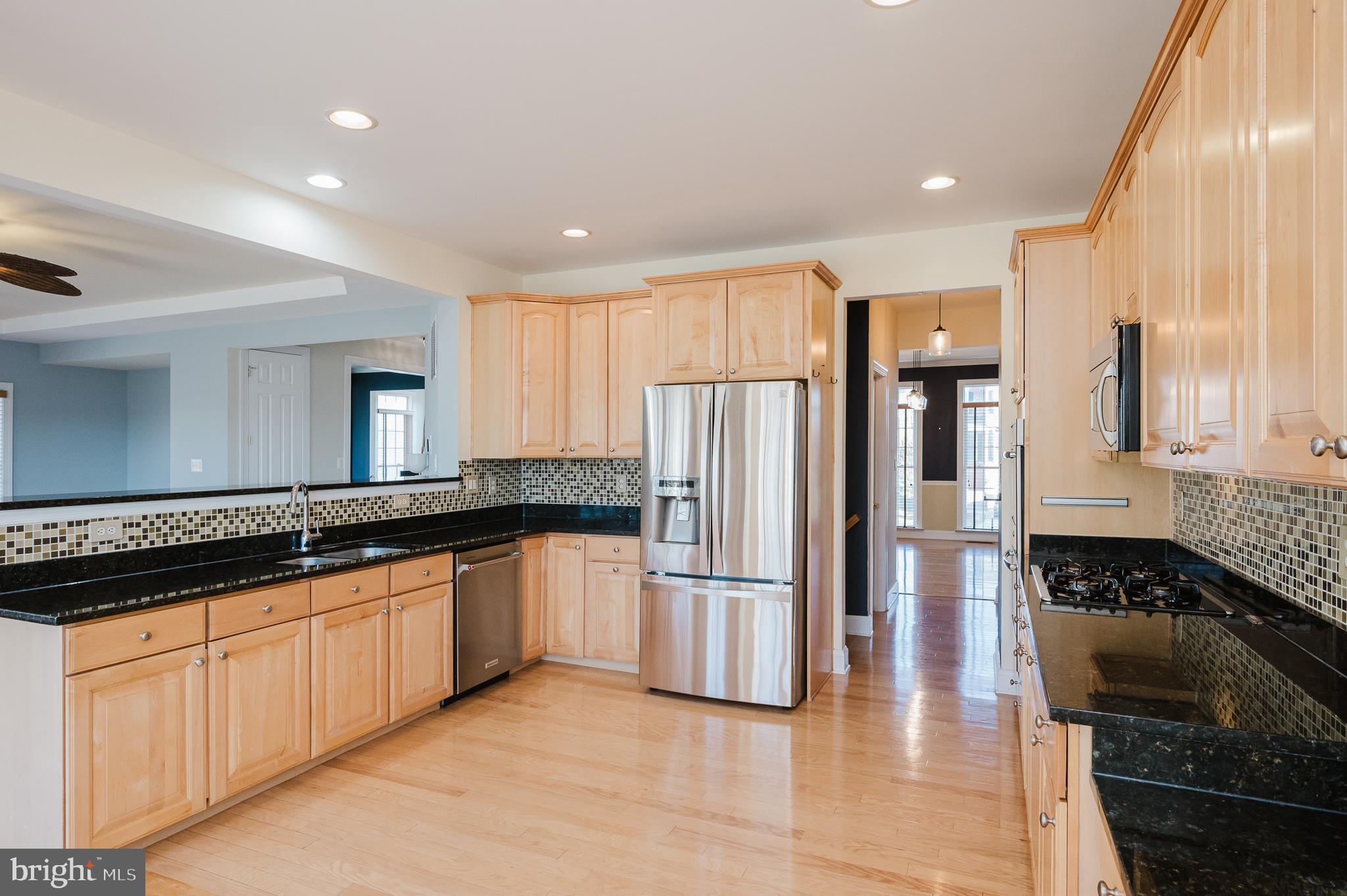 130 Fallston Meadow Court Fallston, MD 21047 - Photo 25 of 80 a kitchen with granite countertop a refrigerator and a sink