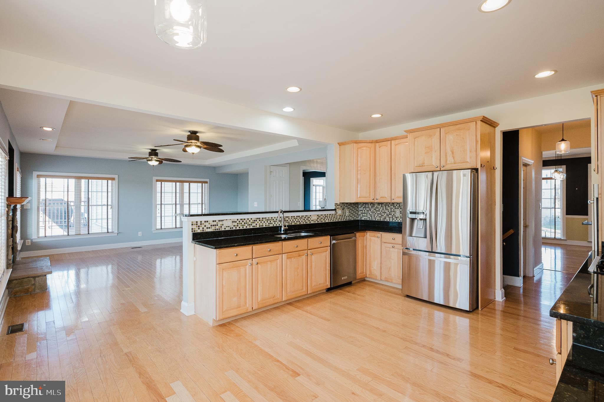 130 Fallston Meadow Court Fallston, MD 21047 - Photo 26 of 80 a kitchen with stainless steel appliances granite countertop a refrigerator a sink dishwasher a stove and a refrigerator with wooden floor
