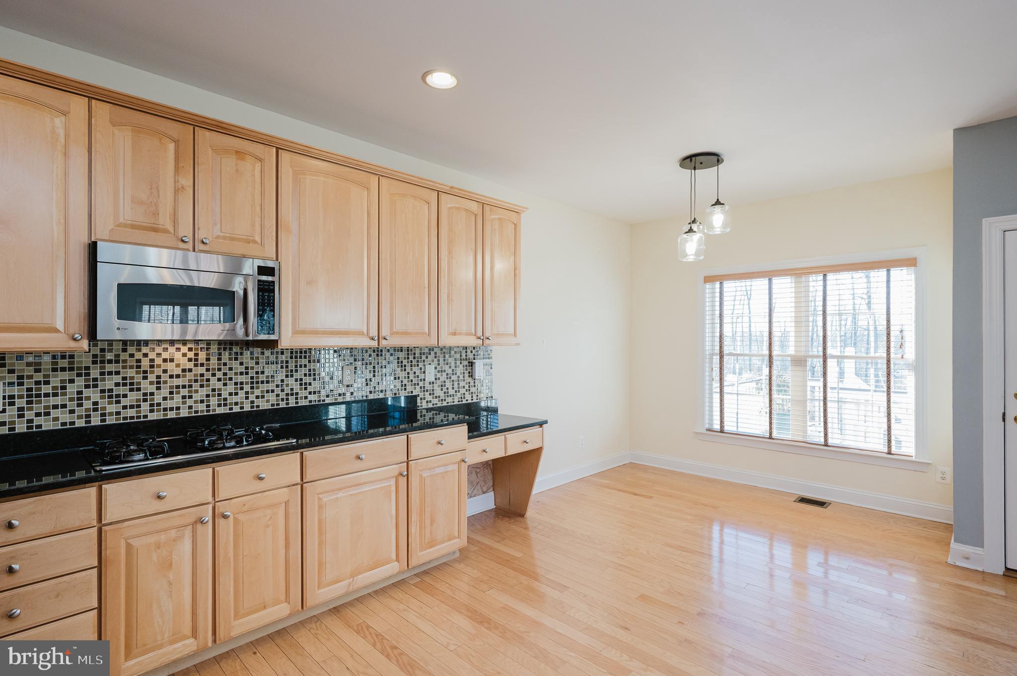 130 Fallston Meadow Court Fallston, MD 21047 - Photo 29 of 80 a kitchen with stainless steel appliances granite countertop a stove a sink and white cabinets with wooden floor
