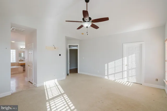 an empty room with windows and closet