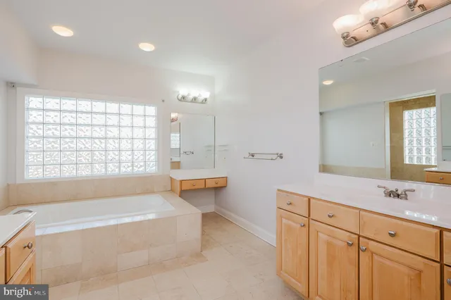 an empty room with wooden floor and stairs