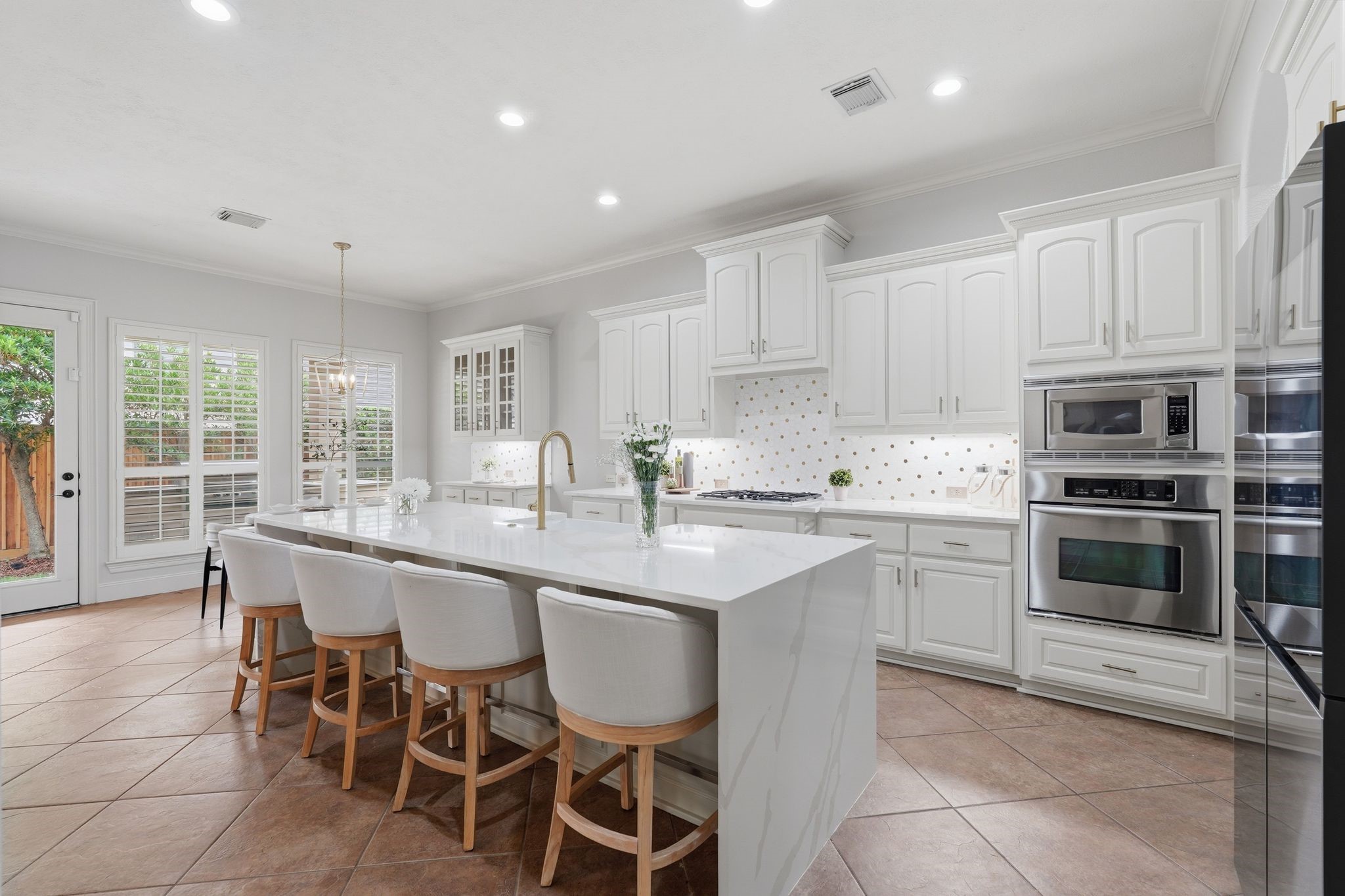 7603 Hogan Bridge Court Spring, TX 77389 - Photo 13 of 50 The heart of the home, this kitchen showcases quartz waterfall countertops and an open layout ideal for gatherings.