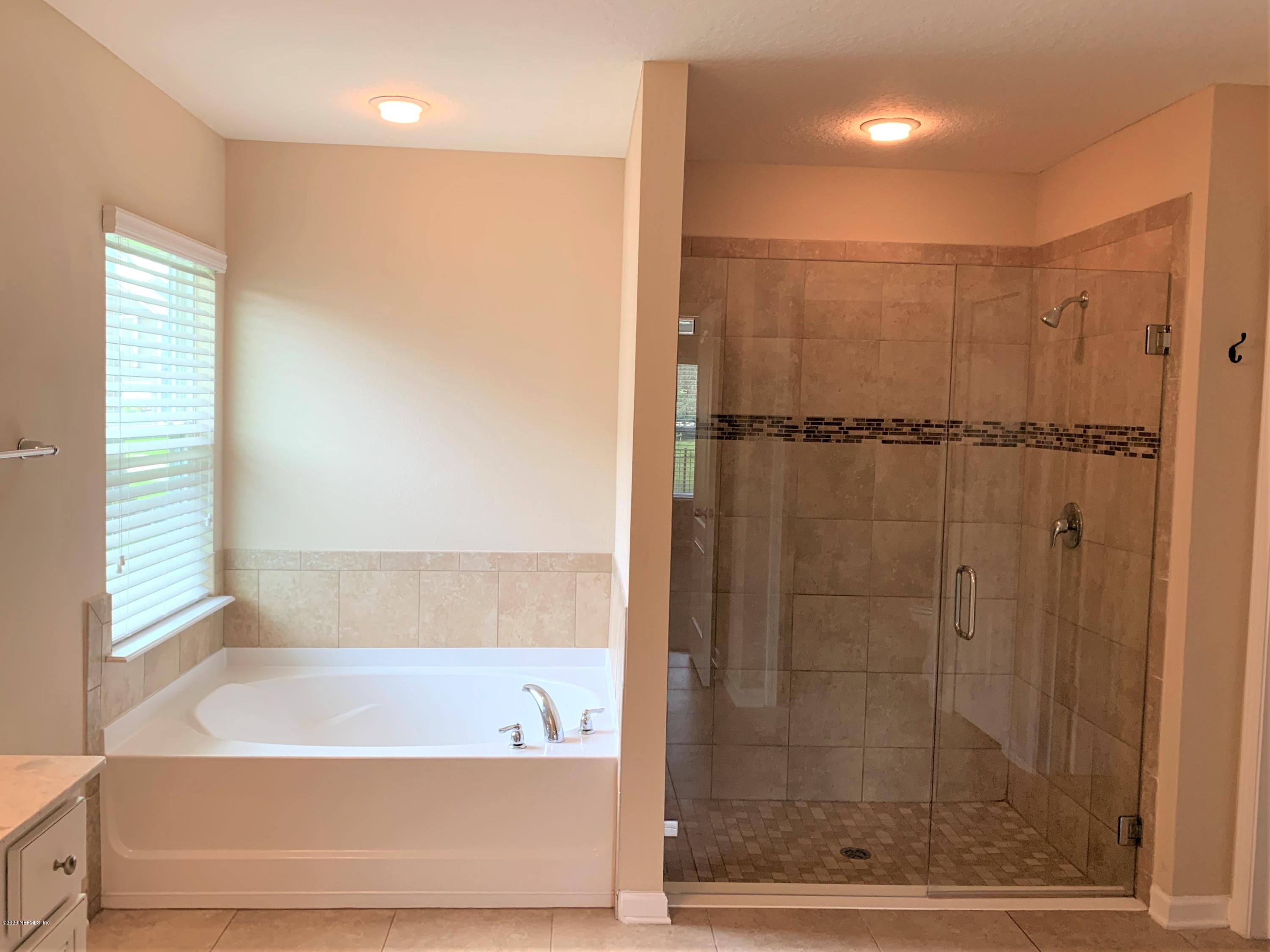 203 Providence Drive St. Augustine, FL 32092 - Photo 11 of 21 a bathroom with a bathtub and a shower