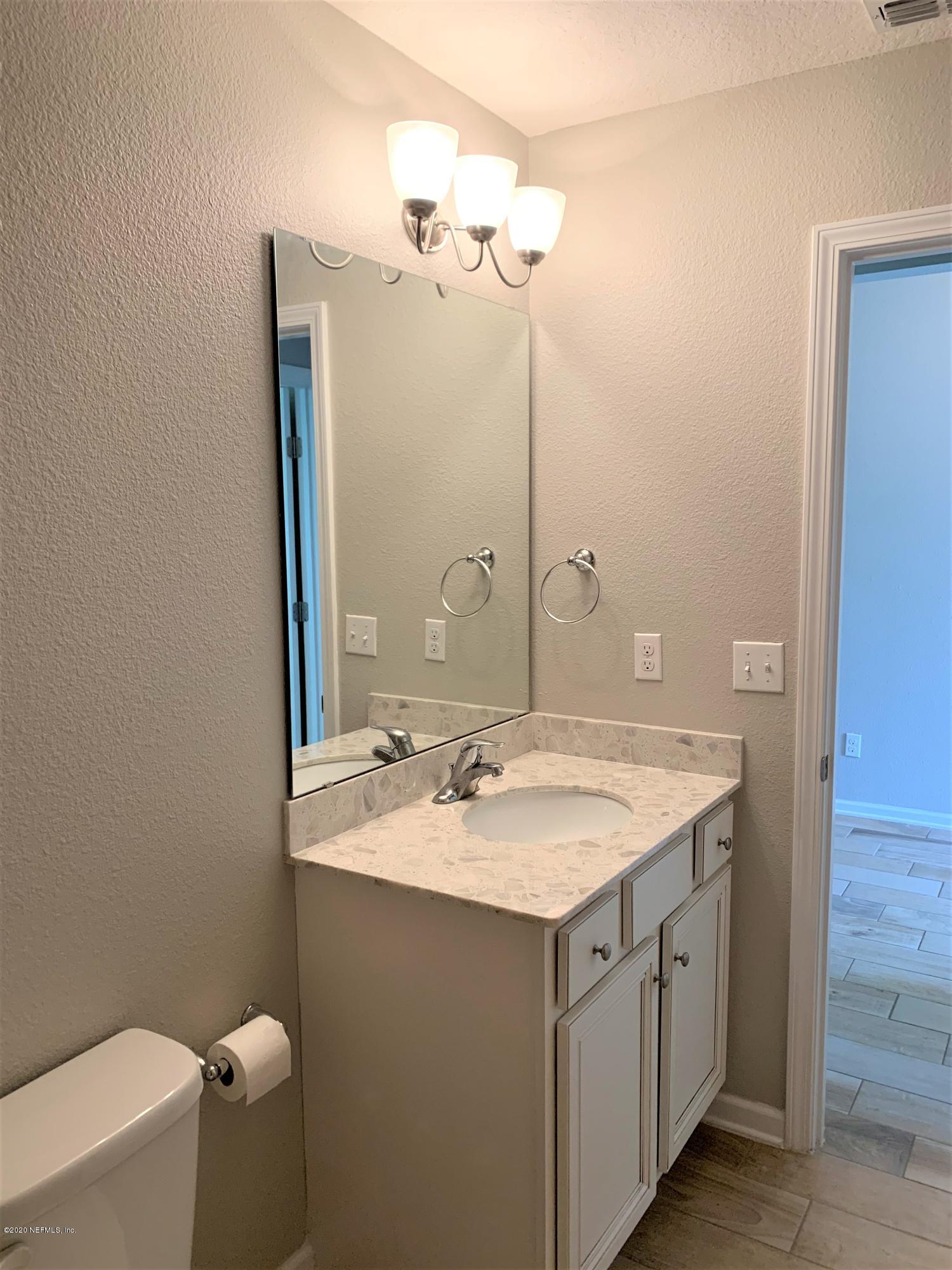 203 Providence Drive St. Augustine, FL 32092 - Photo 14 of 21 a bathroom with a sink and a mirror