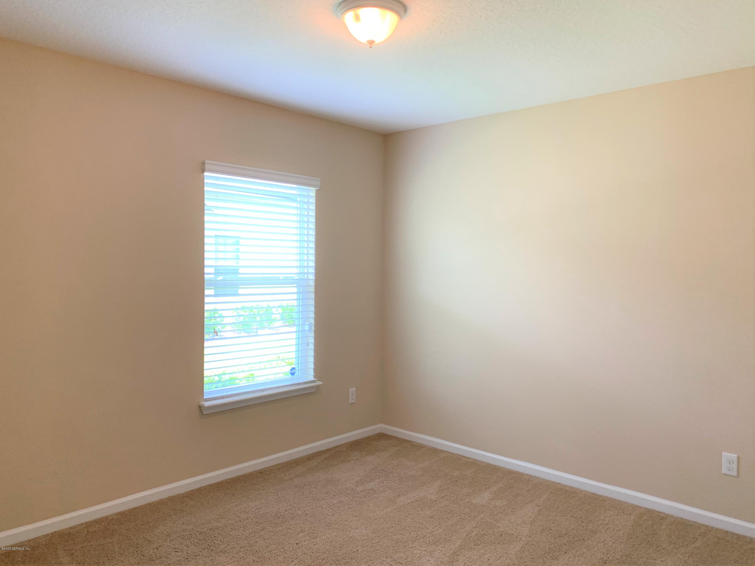 203 Providence Drive St. Augustine, FL 32092 - Photo 16 of 21 an empty room with a window and a mirror