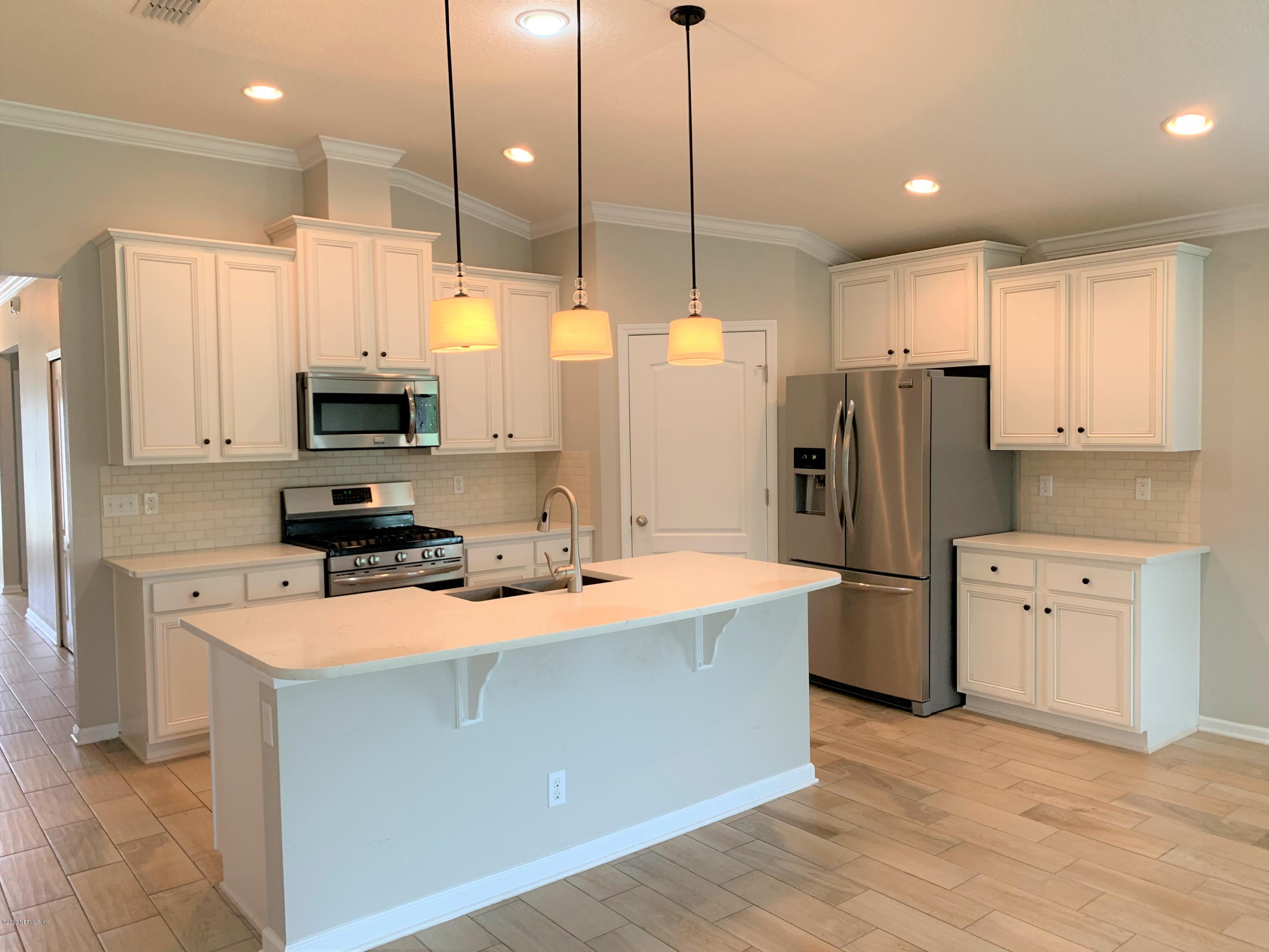 203 Providence Drive St. Augustine, FL 32092 - Photo 2 of 21 a kitchen with stainless steel appliances a stove refrigerator sink and microwave