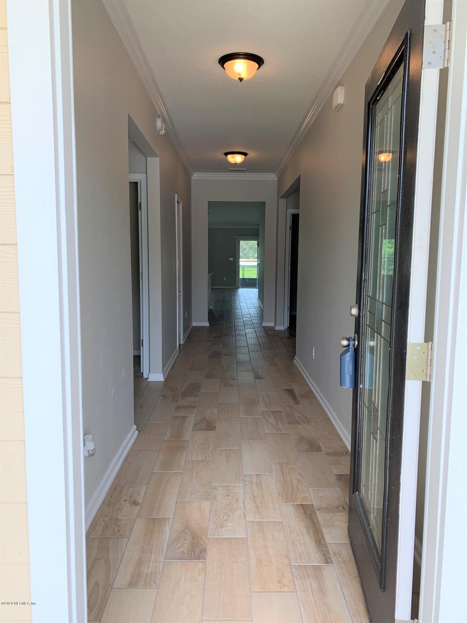 203 Providence Drive St. Augustine, FL 32092 - Photo 5 of 21 a view of a hallway with wooden shelves