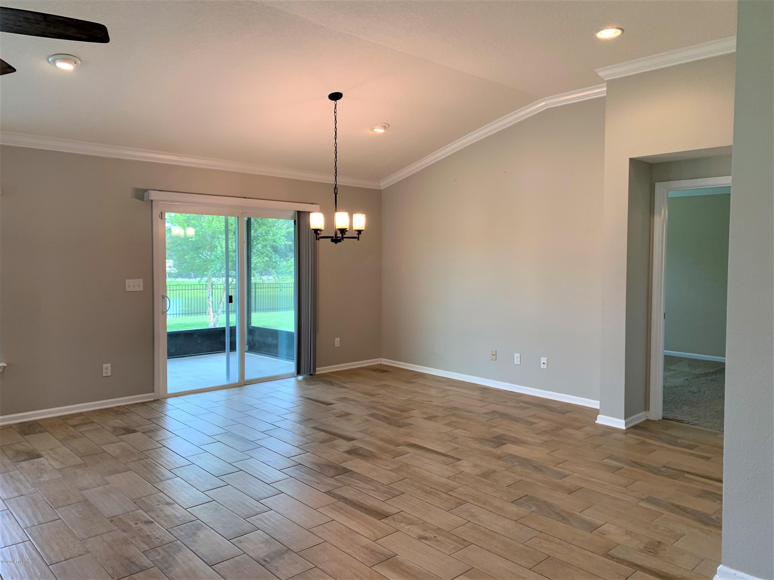 203 Providence Drive St. Augustine, FL 32092 - Photo 7 of 21 a view of an empty room with window and wooden floor