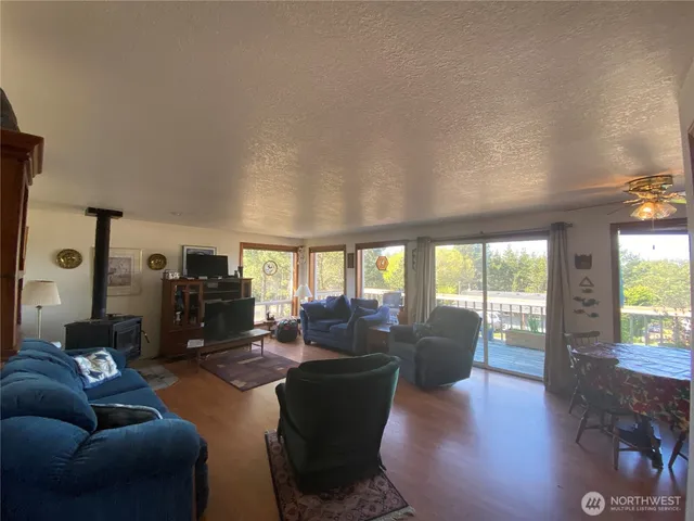 a living room with furniture flat screen tv and a large window