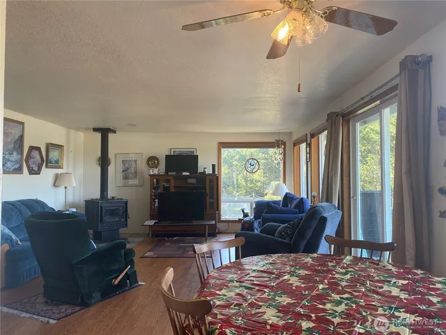 a living room with furniture a flat screen tv and a large window
