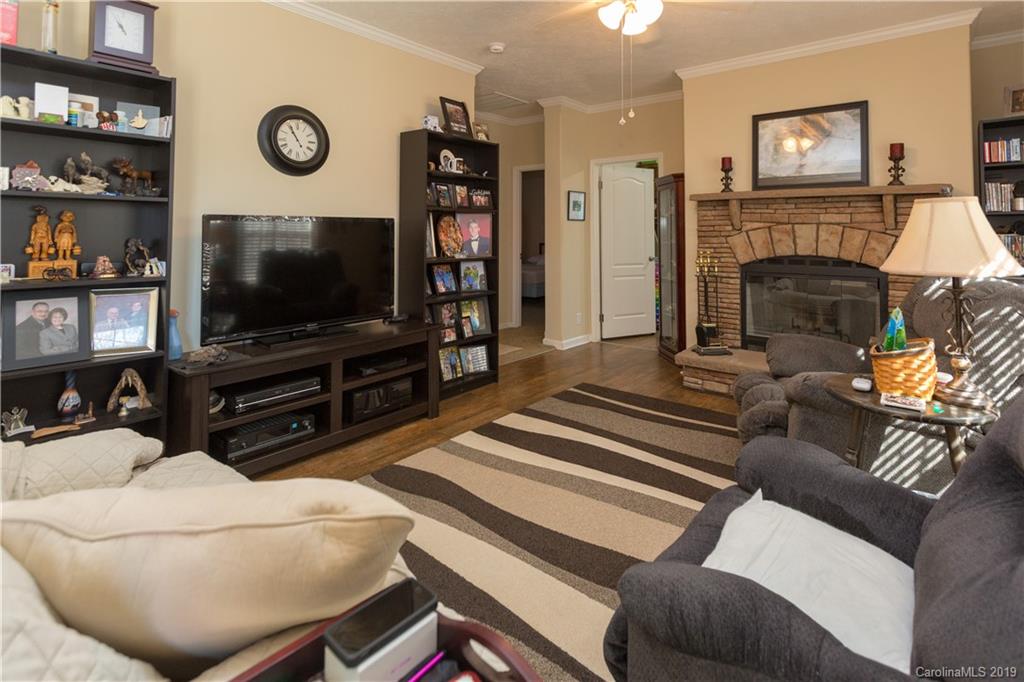 951 Stroupe Road Lancaster, SC 29720 - Photo 17 of 41 a living room with furniture a flat screen tv and a fireplace