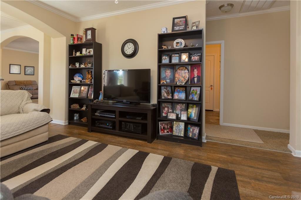951 Stroupe Road Lancaster, SC 29720 - Photo 6 of 41 a living room with bookshelf and wooden floor
