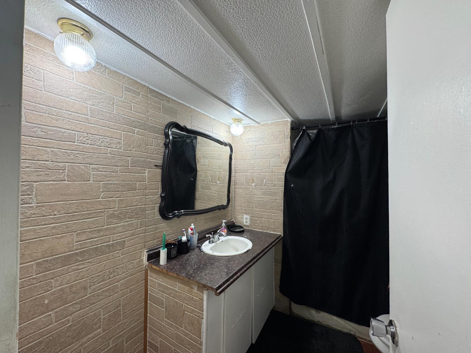 1781 Franklin Road, Unit 36 Yuba City, CA 95993 - Photo 12 of 12 a bathroom with a sink and a mirror