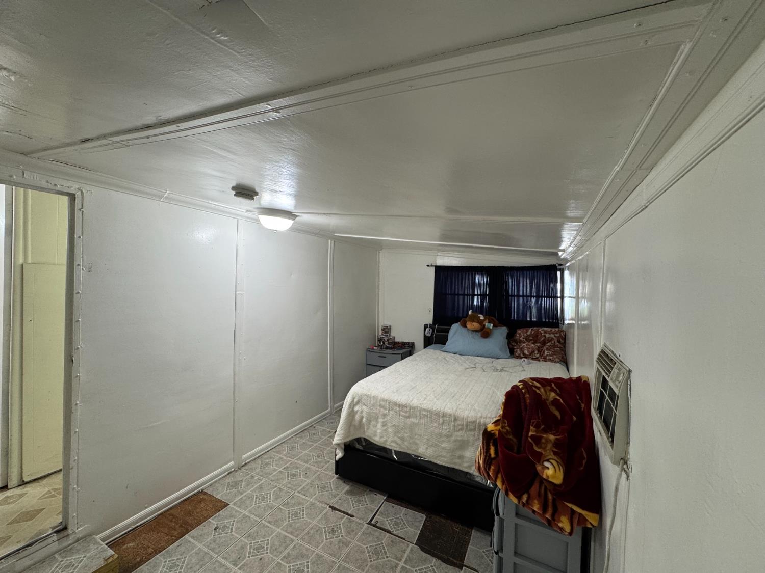 1781 Franklin Road, Unit 36 Yuba City, CA 95993 - Photo 9 of 12 a bedroom with a bed and a chandelier