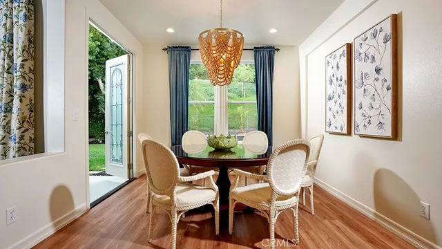 a kitchen with stainless steel appliances granite countertop a sink a stove and a wooden floors