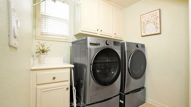 a view of walk in closet with clothes