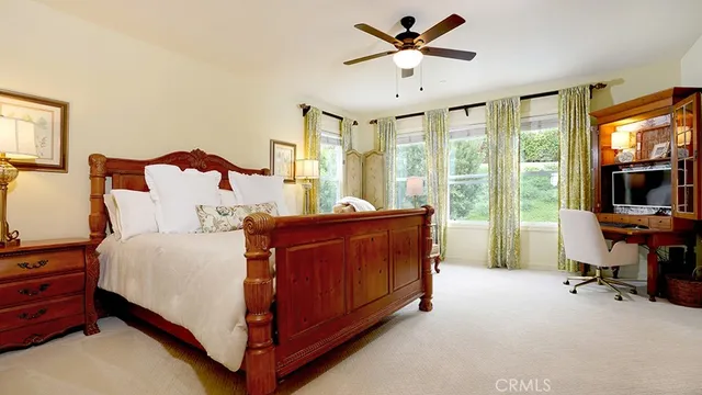 a spacious bedroom with a bed and window