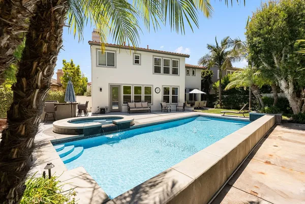 a view of a house with swimming pool and sitting area