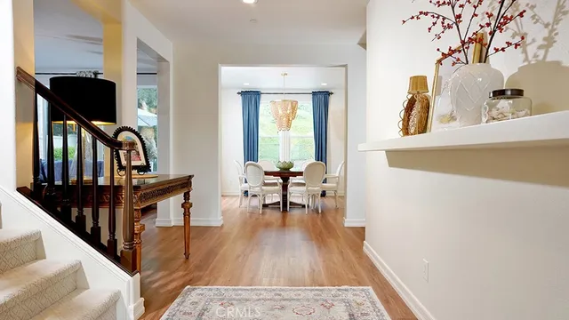 a living room with furniture a chandelier and a flat screen tv