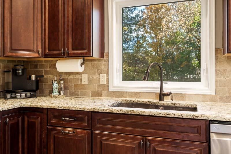 11948 Southgate Road Roscoe, IL 61073 - Photo 24 of 73 a kitchen with granite countertop a sink a window and cabinets