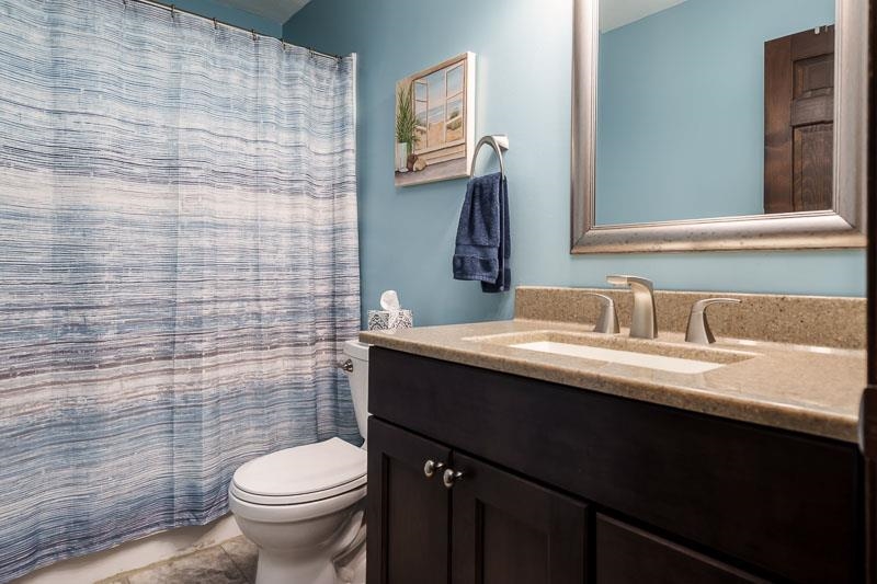11948 Southgate Road Roscoe, IL 61073 - Photo 36 of 73 a bathroom with a granite countertop sink toilet and mirror