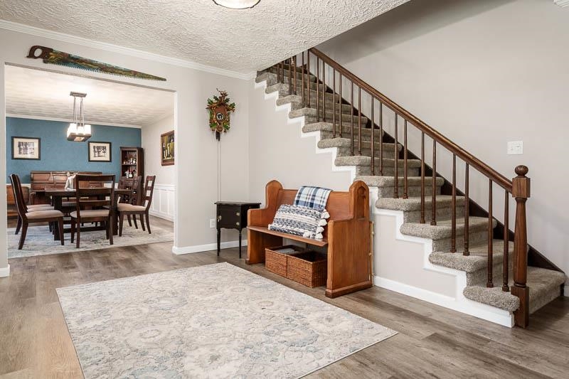 11948 Southgate Road Roscoe, IL 61073 - Photo 4 of 73 a living room with couches and a dining table with wooden floor