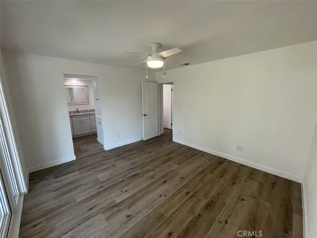 a view of kitchen with granite countertop cabinets a sink and wooden floor