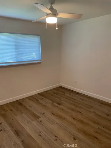 a view of a house with a big yard and large trees