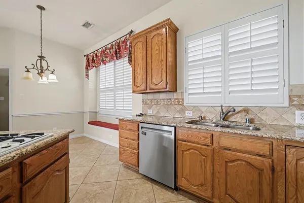 a kitchen with a sink stove top oven and cabinets