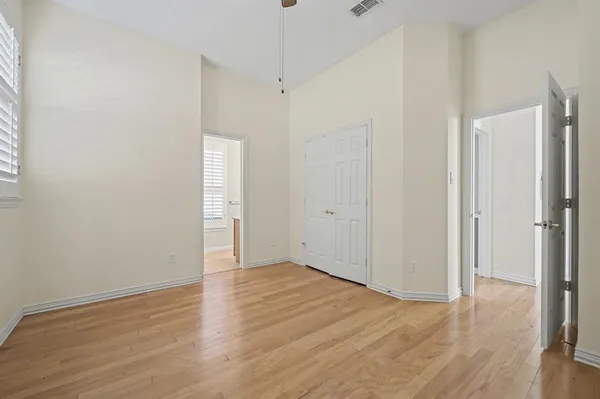 a view of an empty room with wooden floor