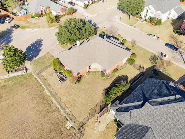 an aerial view of a house with a yard and lake view