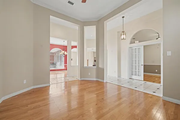 a view of an empty room with cabinet and a window