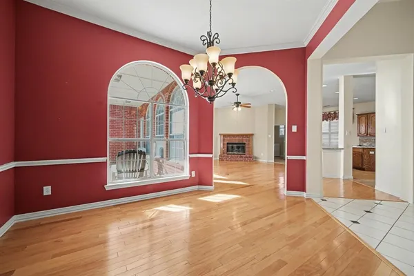 a view of a livingroom with a large window and chandelier