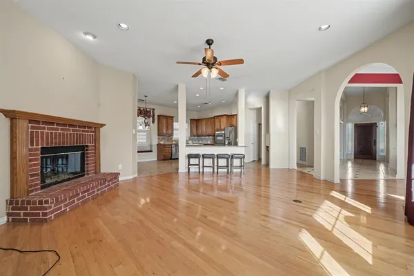 a view of a livingroom with a fireplace and dining area