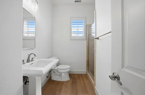 a bathroom with a sink toilet and shower