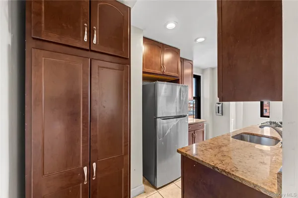 a kitchen with metallic refrigerator freezer and a sink