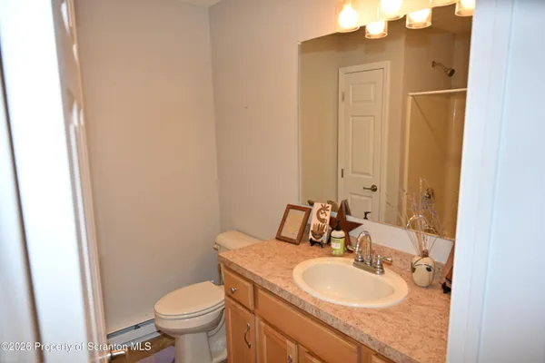 a bathroom with a sink a toilet and mirror