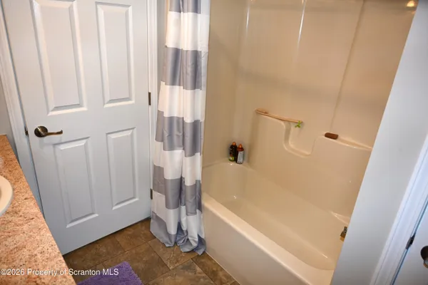 a bathroom with a tub and a shower