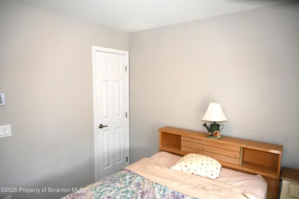 a bedroom with a bed and a lamp