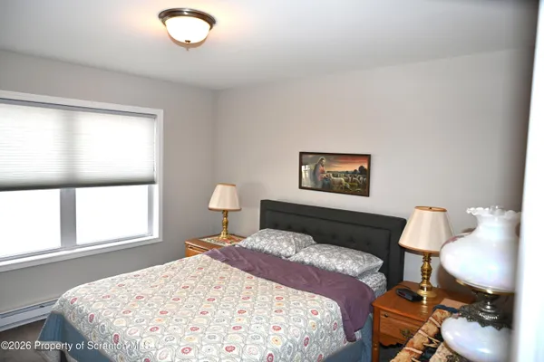 a bedroom with a bed and a lamp