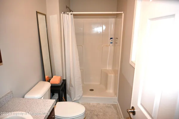 a white toilet sitting next to a bathroom sink