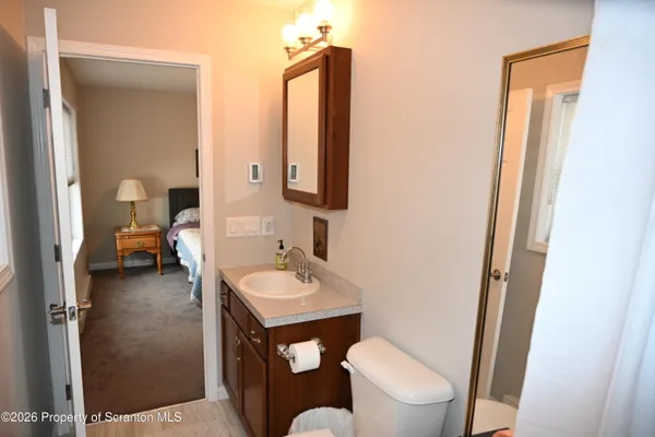 a bathroom with a toilet sink and mirror