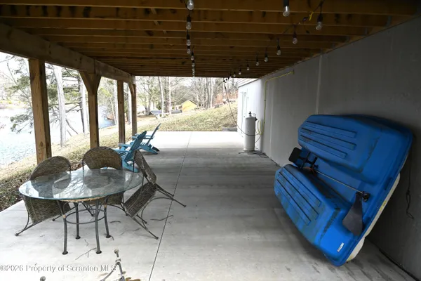 a view of a patio with a table and chairs
