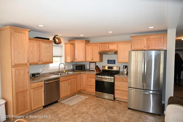 a kitchen with a sink appliances and cabinets
