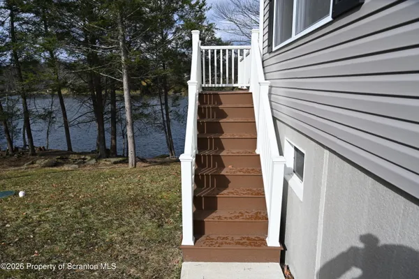 a view of a wooden chairs on the deck