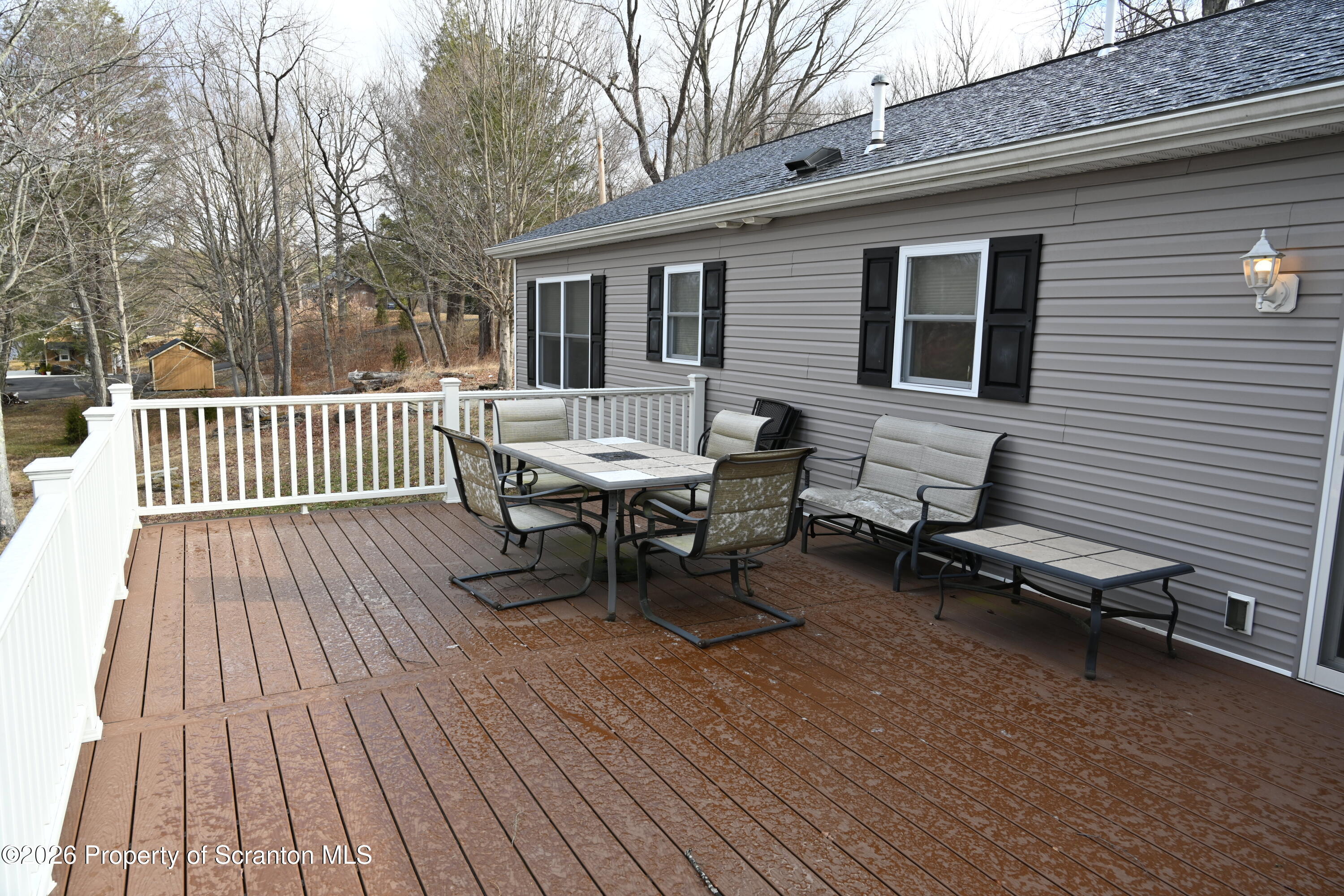 1143 Highway 29 Springville, PA 18844 - Photo 34 of 44 a roof deck with a table and chairs and wooden floor
