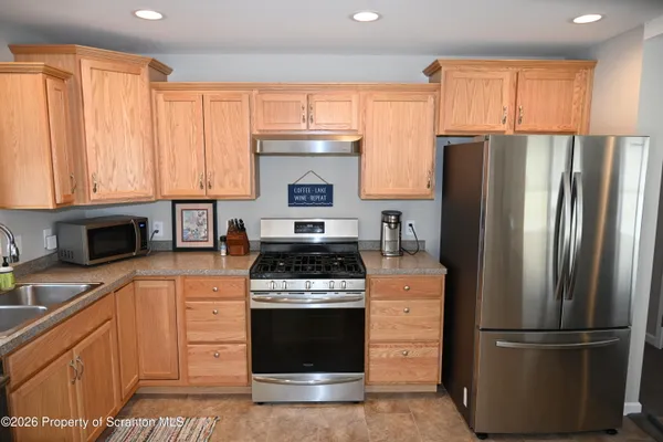 a kitchen with a refrigerator stove and microwave
