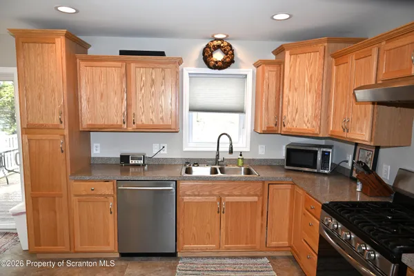 a kitchen with stainless steel appliances a sink stove and cabinets