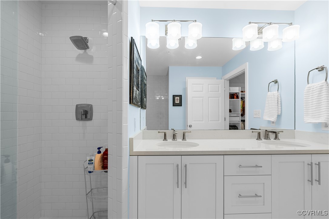 413 Stuart Circle, Unit PLD Richmond, VA 23220 - Photo 23 of 47 a bathroom with a double vanity sink a mirror and shower