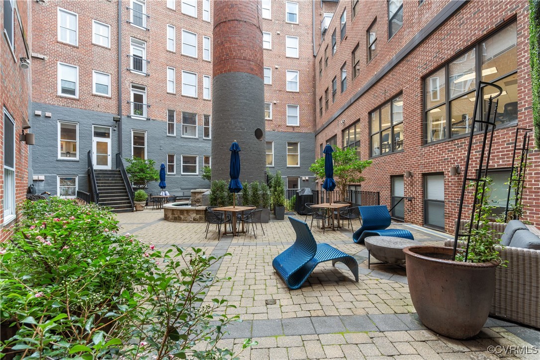 413 Stuart Circle, Unit PLD Richmond, VA 23220 - Photo 28 of 47 a view of a patio with couches table and chairs and potted plants
